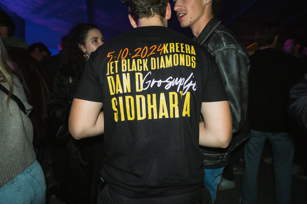 Obiskovalec v majici z zasedbo Glasbenega Atlasa 2024: Siddharta, Dan D, Jet Black Diamonds in Kreera.